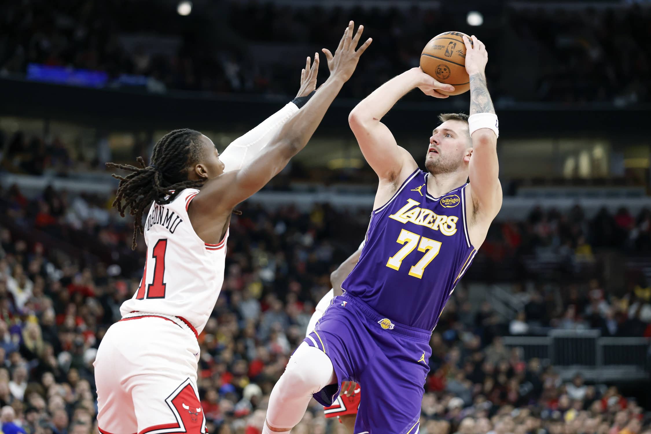 Jan 26, 2026; Chicago, Illinois, USA; Los Angeles Lakers guard Luka Doncic (77) shoots against Chicago Bulls guard Ayo Dosunmu (11) during the second half at United Center. Mandatory Credit: Kamil Krzaczynski-Imagn Images