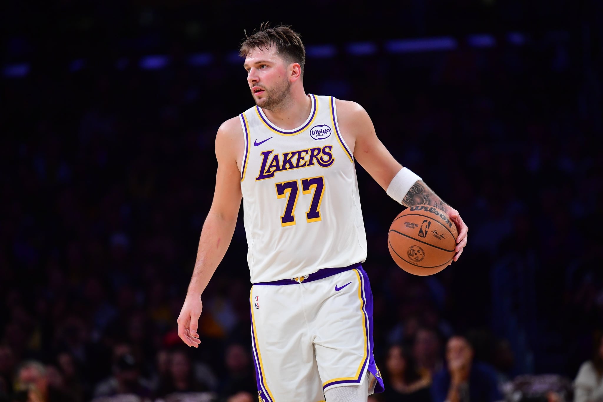 Los Angeles, California, USA; Los Angeles Lakers guard Luka Doncic (77) controls the ball against the New Orleans Pelicans during the first half at Crypto.com Arena. Mandatory Credit: Gary A. Vasquez-Imagn Images