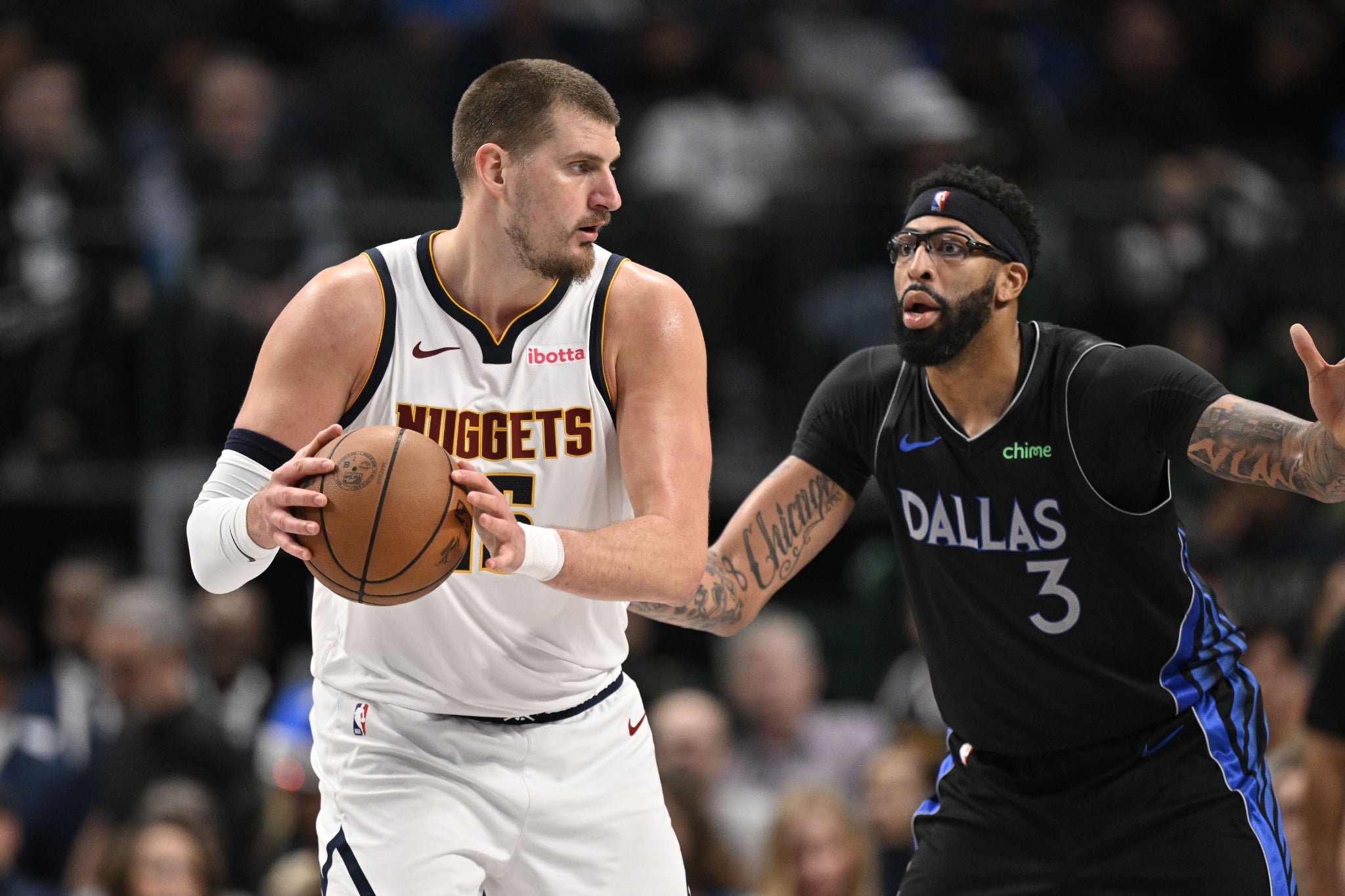 Dec 23, 2025; Dallas, Texas, USA; Denver Nuggets center Nikola Jokic (15) looks to move the ball past Dallas Mavericks forward Anthony Davis (3) during the second half at the American Airlines Center. Mandatory Credit: Jerome Miron-Imagn Images