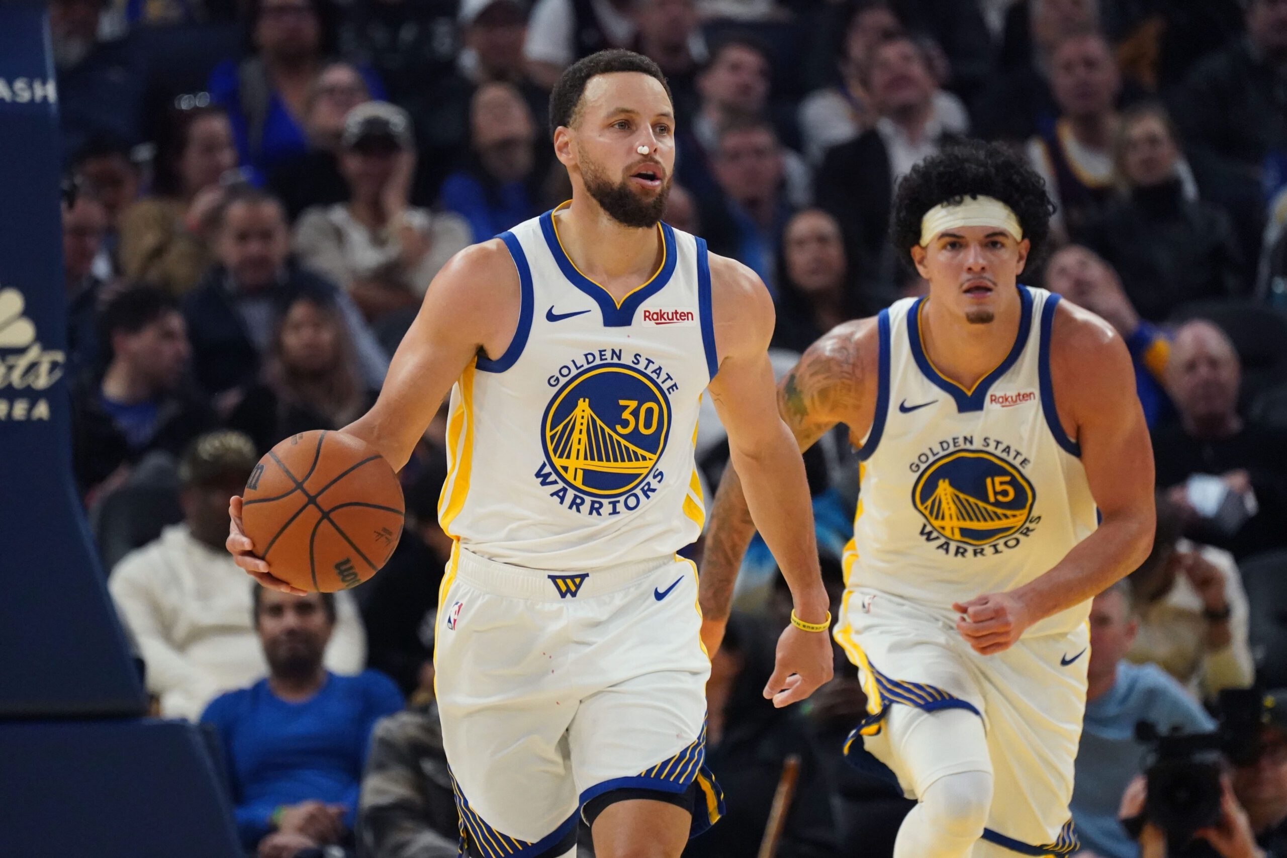 Jan 20, 2026; San Francisco, California, USA; Golden State Warriors guard Stephen Curry (30) dribbles upcourt against the Toronto Raptors as forward Gui Santos (15) trails in the second quarter at Chase Center. Mandatory Credit: David Gonzales-Imagn Images