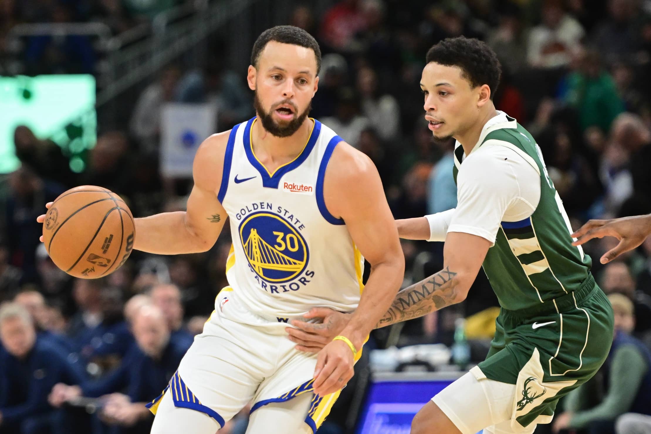 Golden State Warriors guard Stephen Curry (30) looks for a shot against Milwaukee Bucks guard Ryan Rollins (13) in the first quarter at Fiserv Forum.