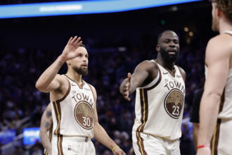Golden State Warriors guard Stephen Curry (30) and forward Draymond Green (23) high five guard Brandin Podziemski (2) after a play against the Sacramento Kings during the fourth quarter at Chase Center. Mandatory Credit: Kelley L Cox-Imagn Images