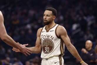 San Francisco, California, USA; Golden State Warriors guard Stephen Curry (30) high fives a teammate between plays against the Sacramento Kings during the first quarter at Chase Center. Mandatory Credit: Kelley L Cox-Imagn Images
