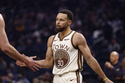 San Francisco, California, USA; Golden State Warriors guard Stephen Curry (30) high fives a teammate between plays against the Sacramento Kings during the first quarter at Chase Center. Mandatory Credit: Kelley L Cox-Imagn Images