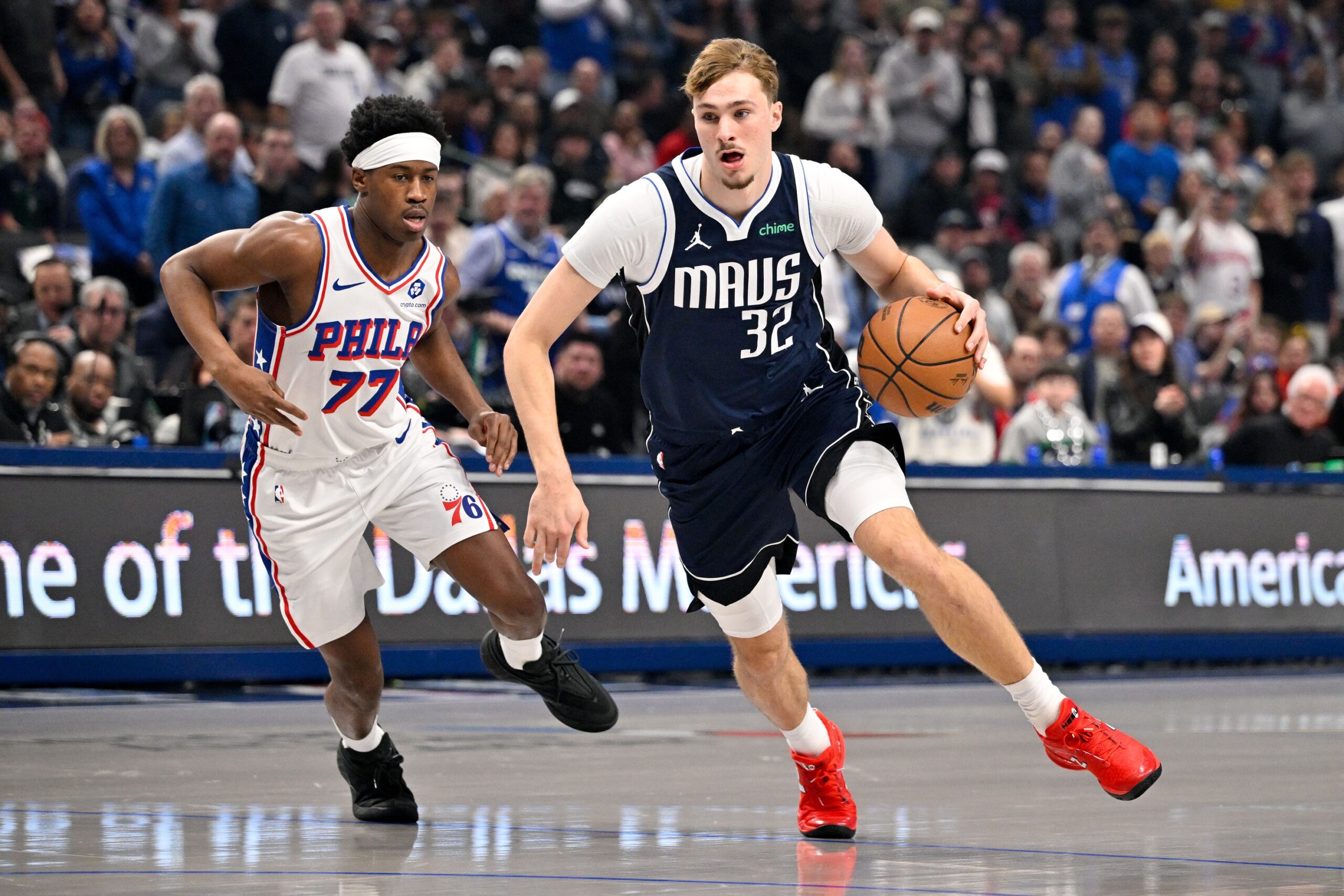 Jan 1, 2026; Dallas, Texas, USA; Dallas Mavericks forward Cooper Flagg (32) drives to the basket past Philadelphia 76ers guard Vj Edgecombe (77) during the first quarter at the American Airlines Center. Mandatory Credit: Jerome Miron-Imagn Images