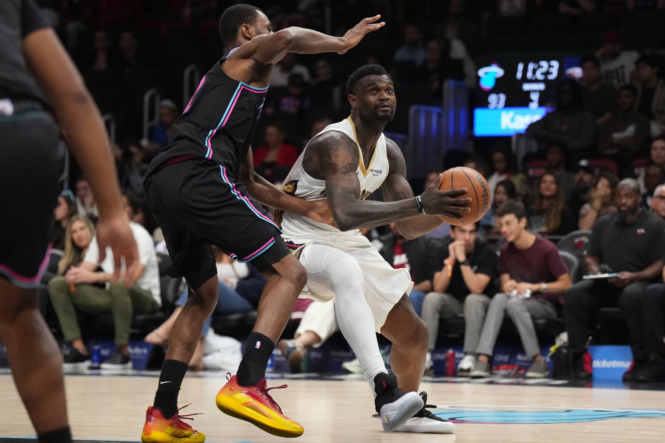 Jan 4, 2026; Miami, Florida, USA; New Orleans Pelicans forward Zion Williamson (1) drives to the basket as Miami Heat forward Andrew Wiggins (22) defends during the second half at Kaseya Center. Mandatory Credit: Jim Rassol-Imagn Images