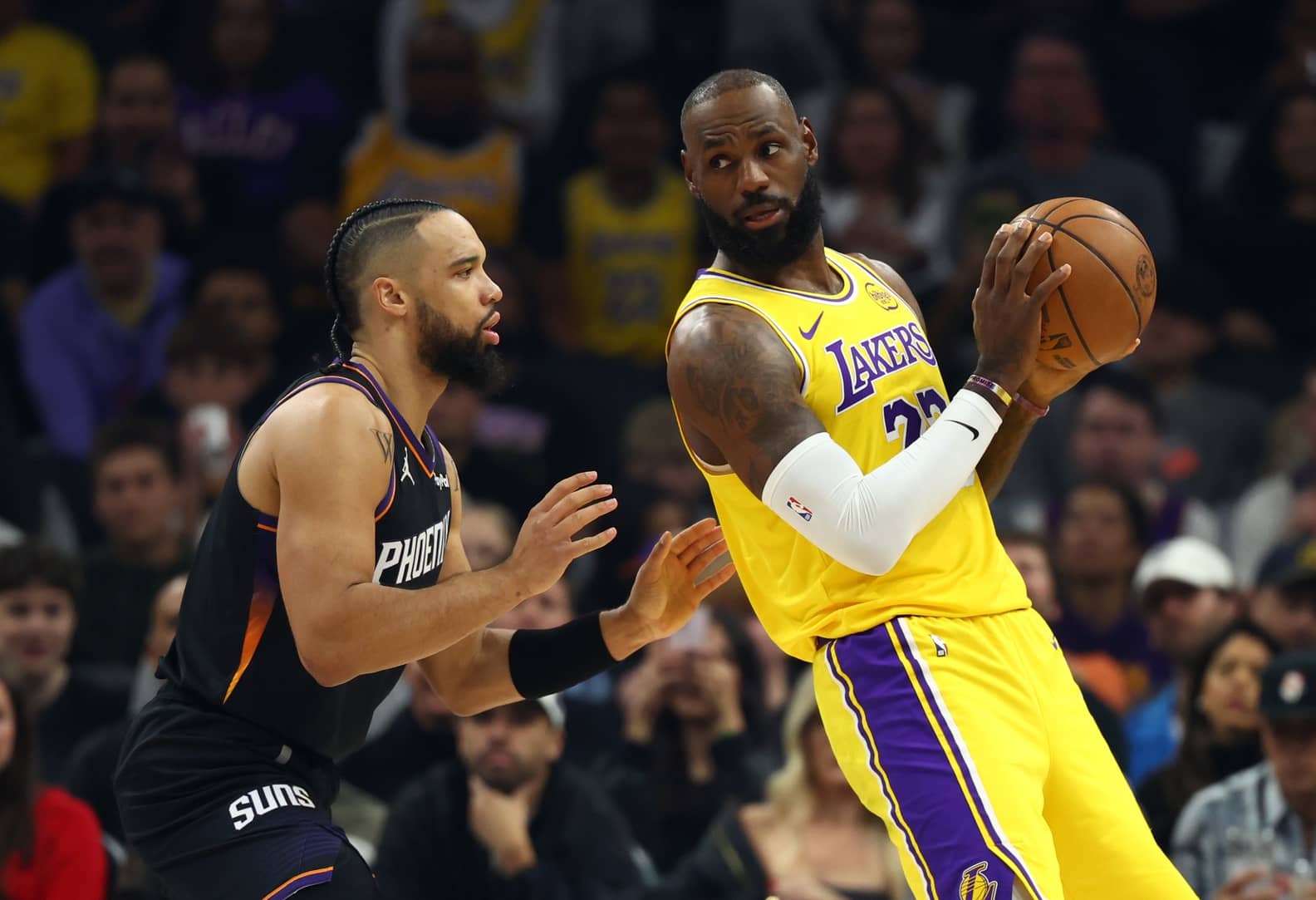 Phoenix, Arizona, USA; Los Angeles Lakers forward LeBron James (23) against Phoenix Suns forward Dillon Brooks (3) at Mortgage Matchup Center. Mandatory Credit: Mark J. Rebilas-Imagn Images