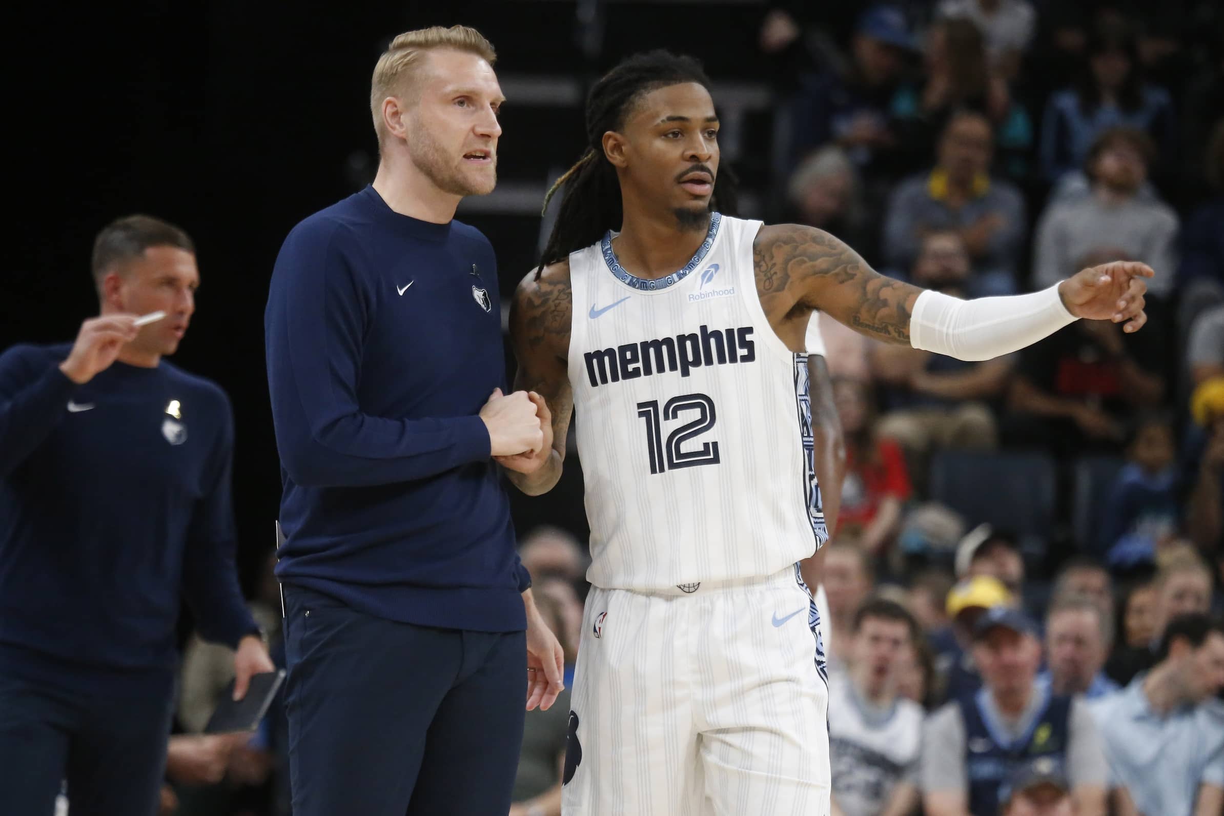 Memphis, Tennessee, USA; Memphis Grizzlies head coach Tuomas Iisalo talks with guard Ja Morant (12) during the fourth quarter against the Milwaukee Bucks at FedExForum. Mandatory Credit: Petre Thomas-Imagn Images