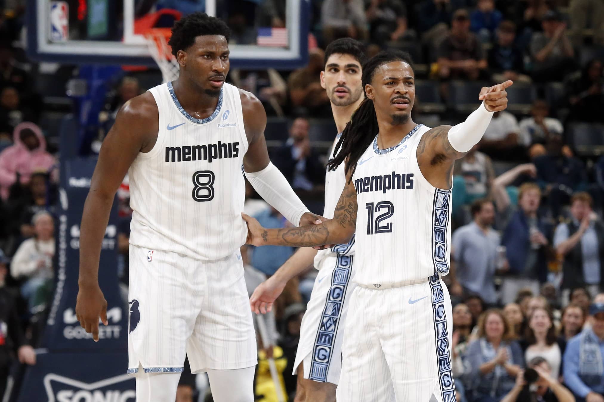Memphis, Tennessee, USA; Memphis Grizzlies guard Ja Morant (12) reacts with forward/center Jaren Jackson Jr. (8) during the fourth quarter against the Milwaukee Bucks at FedExForum. Mandatory Credit: Petre Thomas-Imagn Images