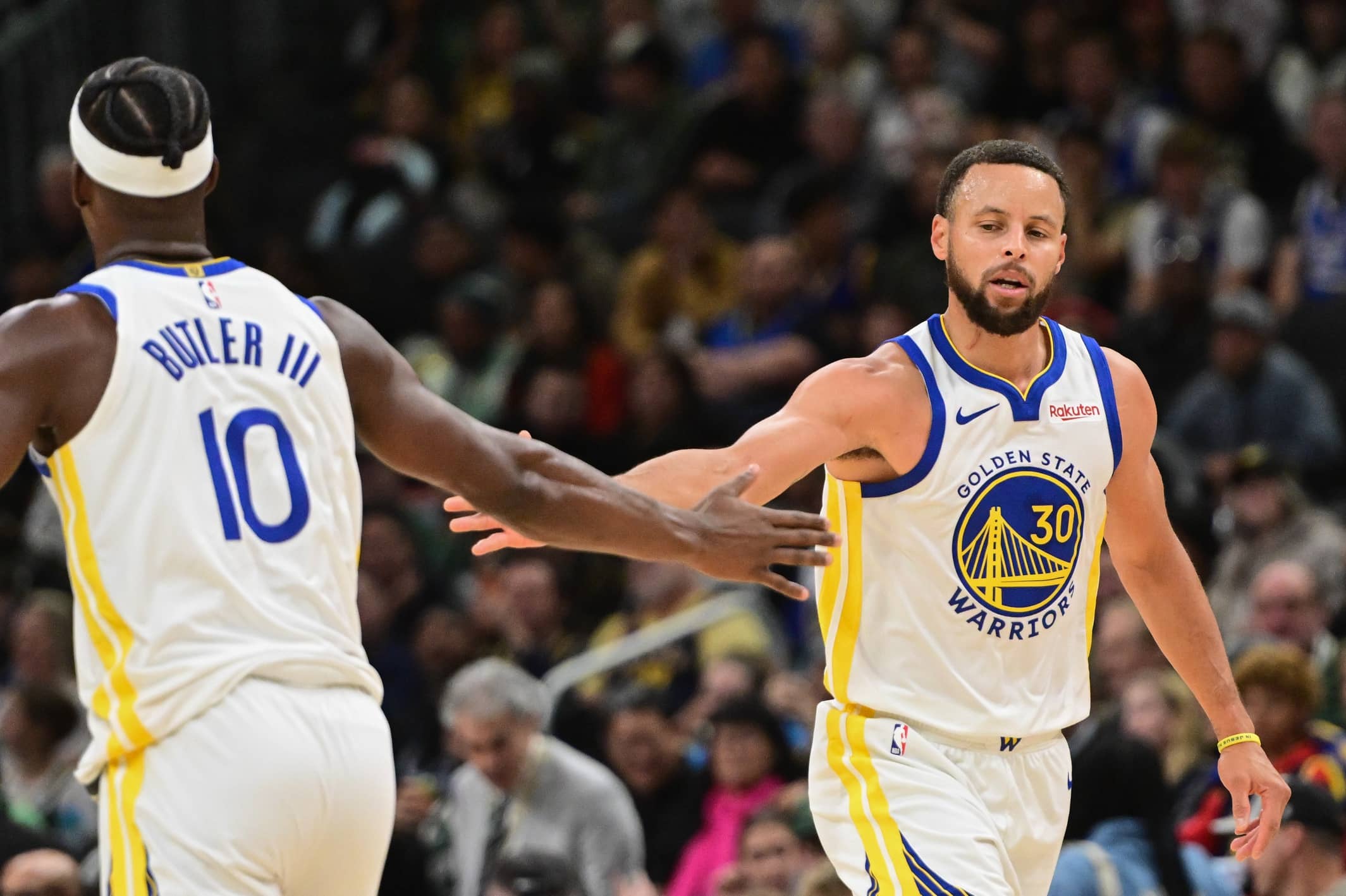 Milwaukee, Wisconsin, USA; Golden State Warriors guard Stephen Curry (30) reacts with forward Jimmy Butler (10) after scoring a basket in the 3rd quarter against the Milwaukee Bucks at Fiserv Forum. Mandatory Credit: Benny Sieu-Imagn Images