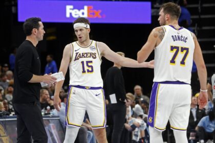 Memphis, Tennessee, USA; Los Angeles Lakers head coach JJ Redick talks with guard Austin Reaves (15) and guard Luka Doncic (77) during the fourth quarter against the Memphis Grizzlies at FedExForum. Mandatory Credit: Petre Thomas-Imagn Images