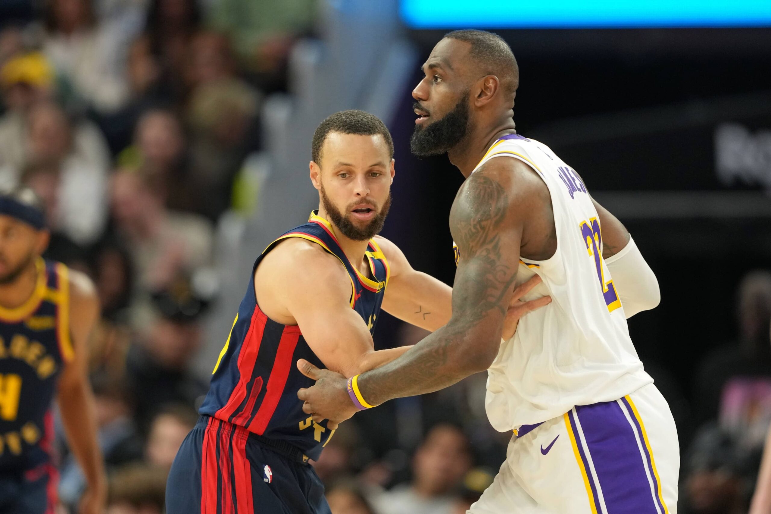 San Francisco, California, USA; Golden State Warriors guard Stephen Curry (left) defends against Los Angeles Lakers forward LeBron James (right) during the fourth quarter at Chase Center. Mandatory Credit: Darren Yamashita-Imagn Images