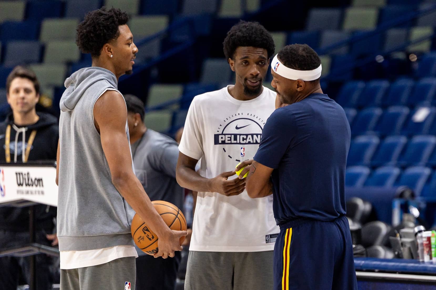 New Orleans, Louisiana, USA; Denver Nuggets guard/forward Bruce Brown (11) talks with New Orleans Pelicans forward Herbert Jones (2) and forward Trey Murphy III (25) during warmups at Smoothie King Center. Mandatory Credit: Stephen Lew-Imagn Images