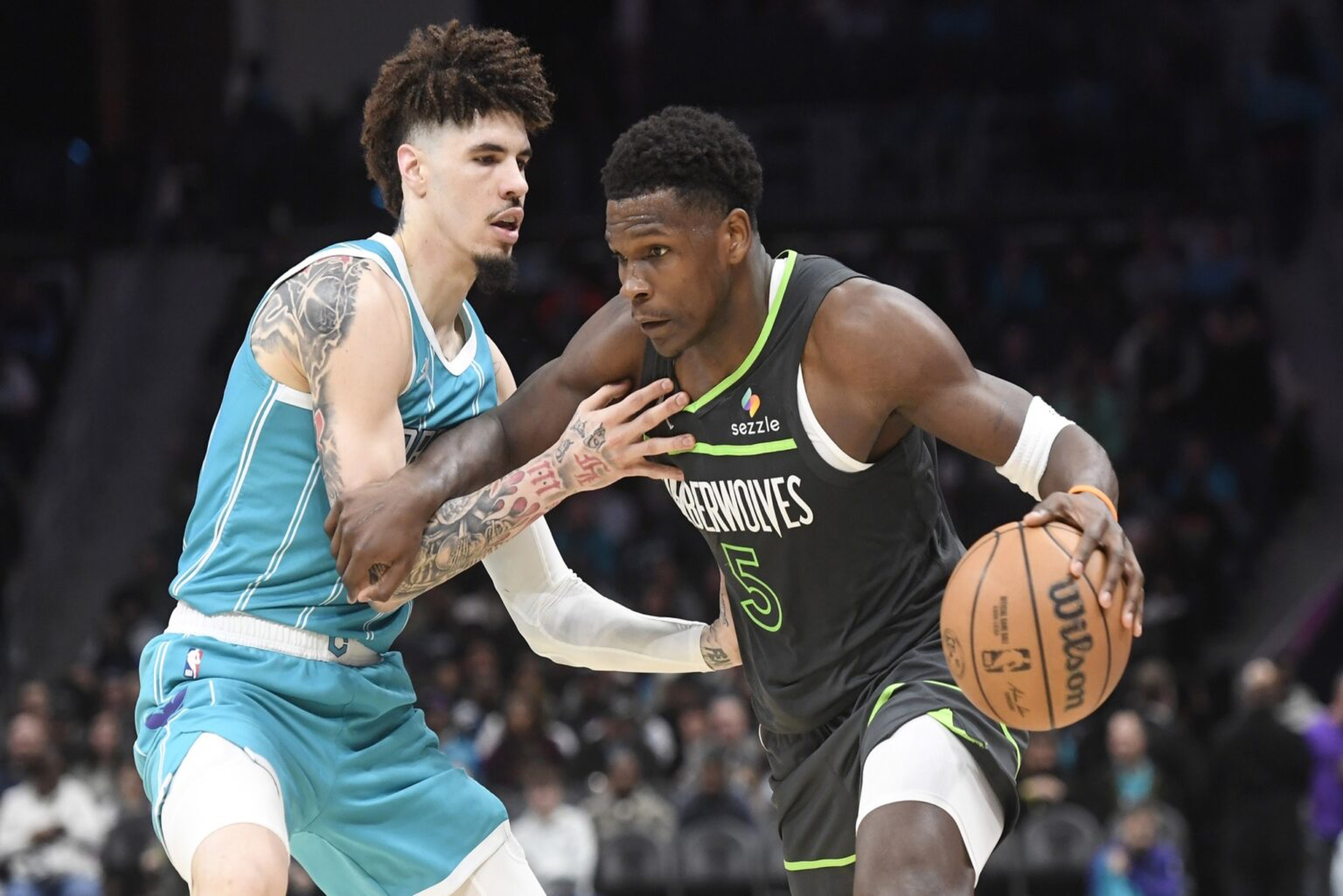 Mar 5, 2025; Charlotte, North Carolina, USA; Minnesota Timberwolves guard Anthony Edwards (5) drives past Charlotte Hornets guard LaMelo Ball (1) during the second half at the Spectrum Center. Mandatory Credit: Sam Sharpe-Imagn Images