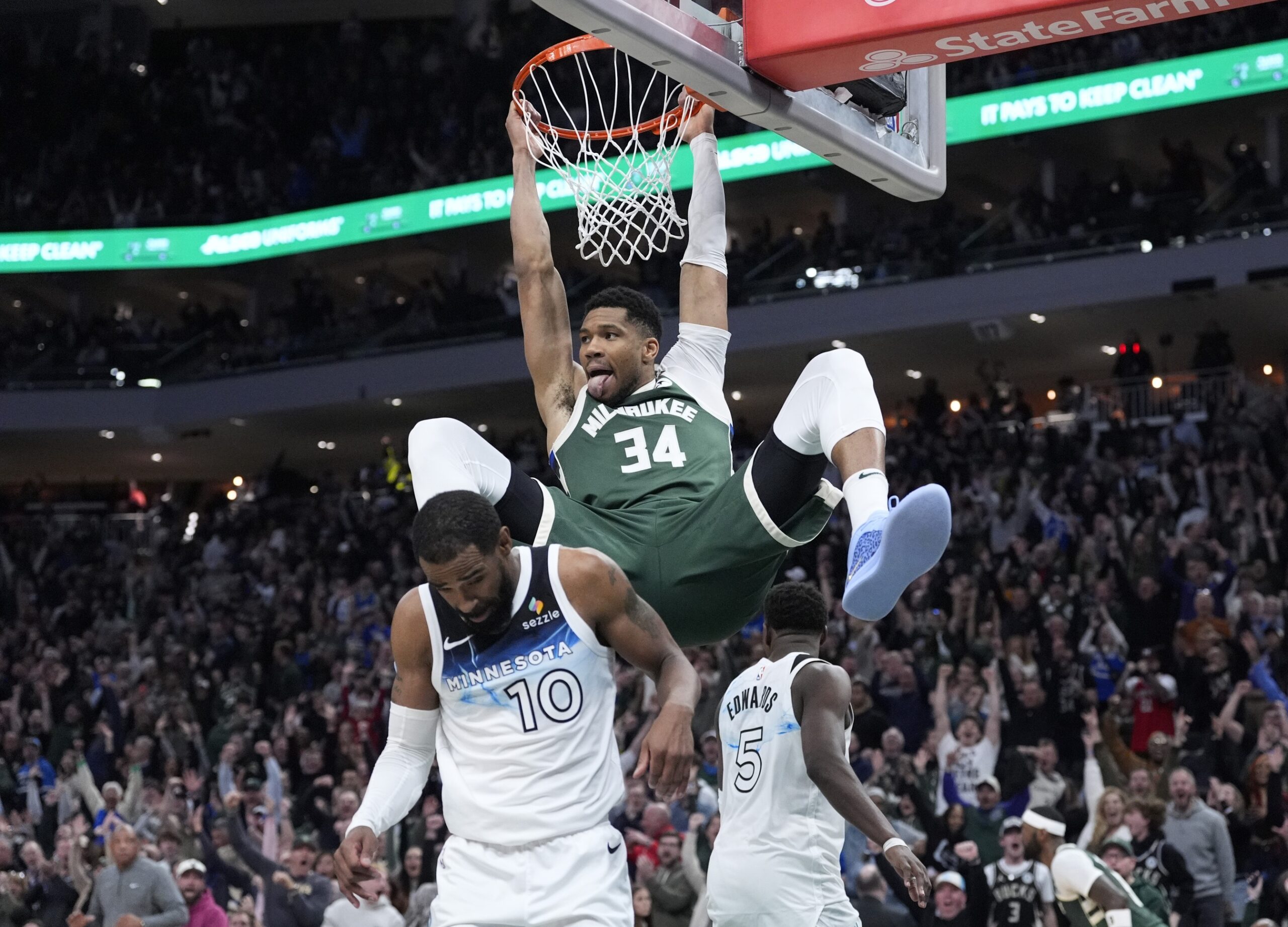 Apr 8, 2025; Milwaukee, Wisconsin, USA; Milwaukee Bucks forward Giannis Antetokounmpo (34) dunks the ball against Minnesota Timberwolves guard Mike Conley (10) in the second half at Fiserv Forum. Mandatory Credit: Michael McLoone-Imagn Images