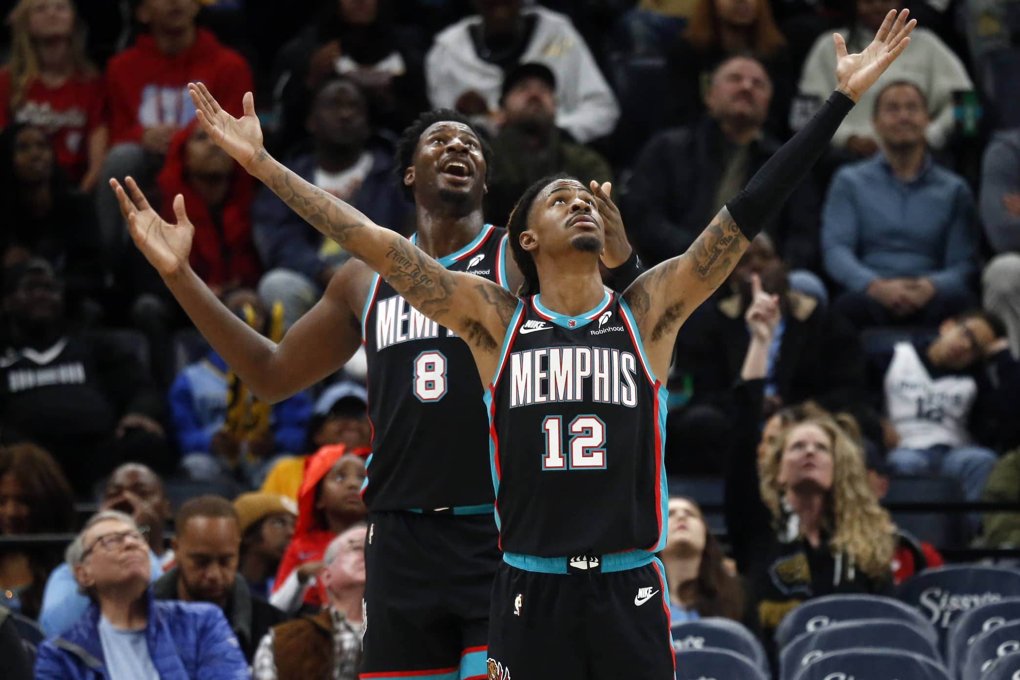 Nov 9, 2025; Memphis, Tennessee, USA; Memphis Grizzlies forward/center Jaren Jackson Jr. (8) and guard Ja Morant (12) react during the third quarter against the Oklahoma City Thunder at FedExForum. Mandatory Credit: Petre Thomas-Imagn Images