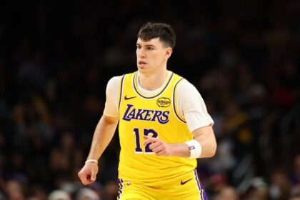 Dec 23, 2025; Phoenix, Arizona, USA; Los Angeles Lakers forward Jake LaRavia (12) against the Phoenix Suns at Mortgage Matchup Center. Mandatory Credit: Mark J. Rebilas-Imagn Images