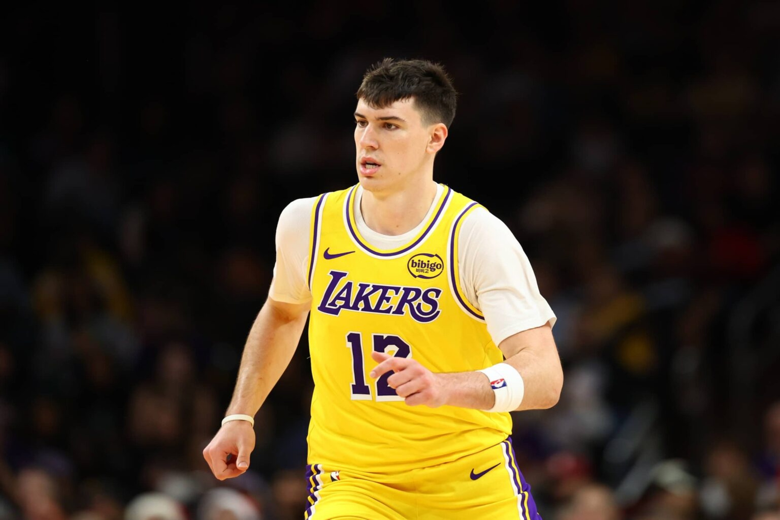 Dec 23, 2025; Phoenix, Arizona, USA; Los Angeles Lakers forward Jake LaRavia (12) against the Phoenix Suns at Mortgage Matchup Center. Mandatory Credit: Mark J. Rebilas-Imagn Images