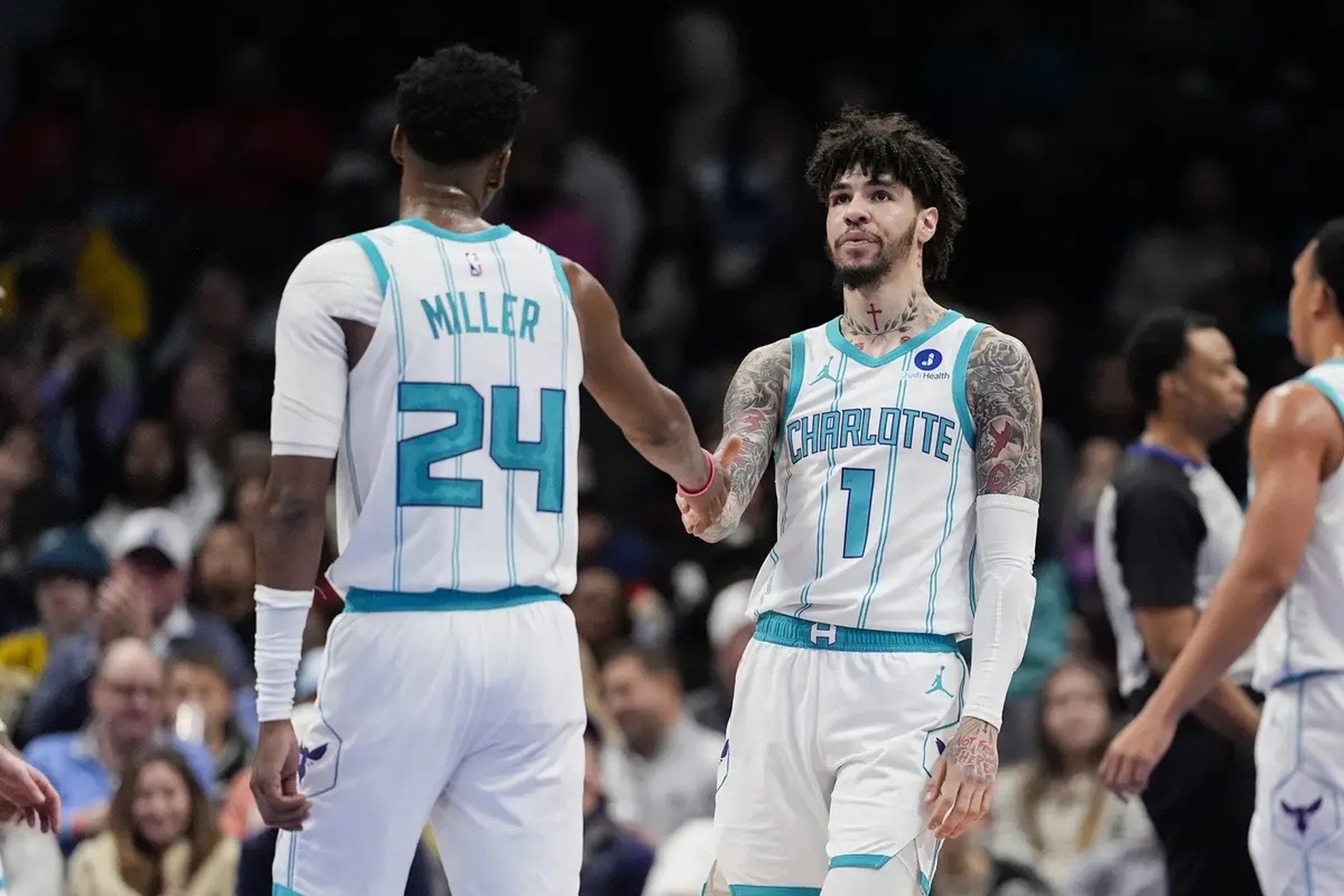 Feb 2, 2026; Charlotte, North Carolina, USA;Charlotte Hornets guard LaMelo Ball (1) and forward Brandon Miller (24) high five during the second quarter against the New Orleans Pelicans at the Spectrum Center. Mandatory Credit: Jim Dedmon-Imagn Images