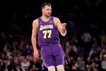 New York, New York, USA; Los Angeles Lakers guard Luka Doncic (77) points in the direction of Knicks fan Spike Lee (not pictured) after a three point shot against the New York Knicks during the third quarter at Madison Square Garden. Mandatory Credit: Brad Penner-Imagn Images