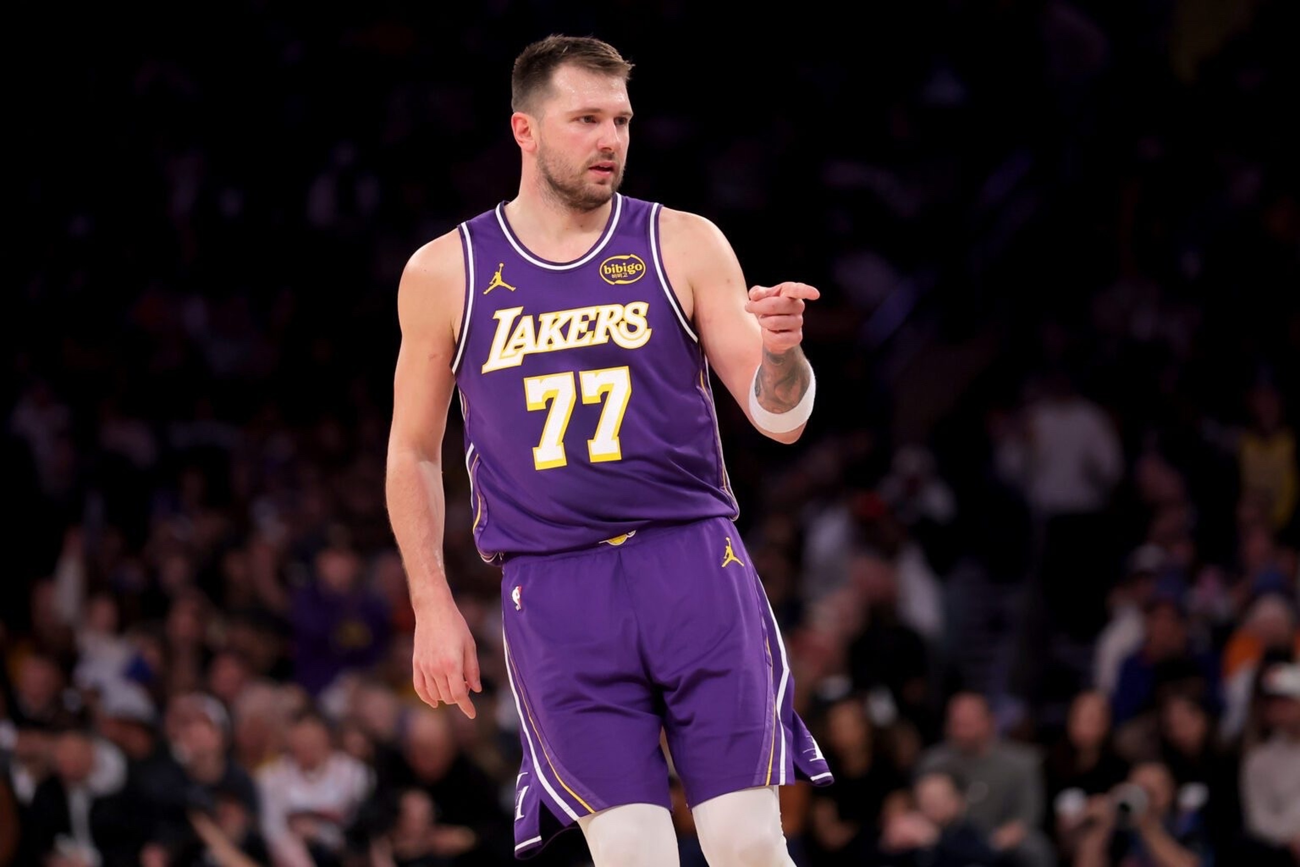 New York, New York, USA; Los Angeles Lakers guard Luka Doncic (77) points in the direction of Knicks fan Spike Lee (not pictured) after a three point shot against the New York Knicks during the third quarter at Madison Square Garden. Mandatory Credit: Brad Penner-Imagn Images