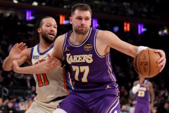 New York, New York, USA; Los Angeles Lakers guard Luka Doncic (77) controls the ball against New York Knicks guard Jalen Brunson (11) during the third quarter at Madison Square Garden. Mandatory Credit: Brad Penner-Imagn Images