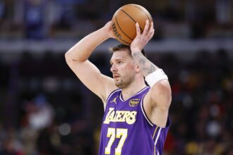 Chicago, Illinois, USA; Los Angeles Lakers guard Luka Doncic (77) looks to pass the ball against the Chicago Bulls during the second half at United Center. Mandatory Credit: Kamil Krzaczynski-Imagn Images