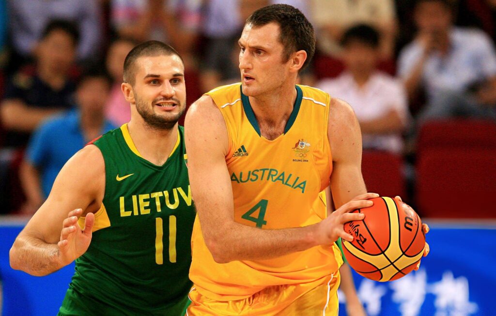BEIJING - AUGUST 18: Chris Anstey #4 of Australia looks to pass the ball against Linas Kleiza #11 of Lithuania during the preliminaries at the Wukesong Indoor Stadium on Day 10 of the Beijing 2008 Olympic Games on August 18, 2008 in Beijing, China. Australia won 106-75. (Photo by Jamie Squire/Getty Images)