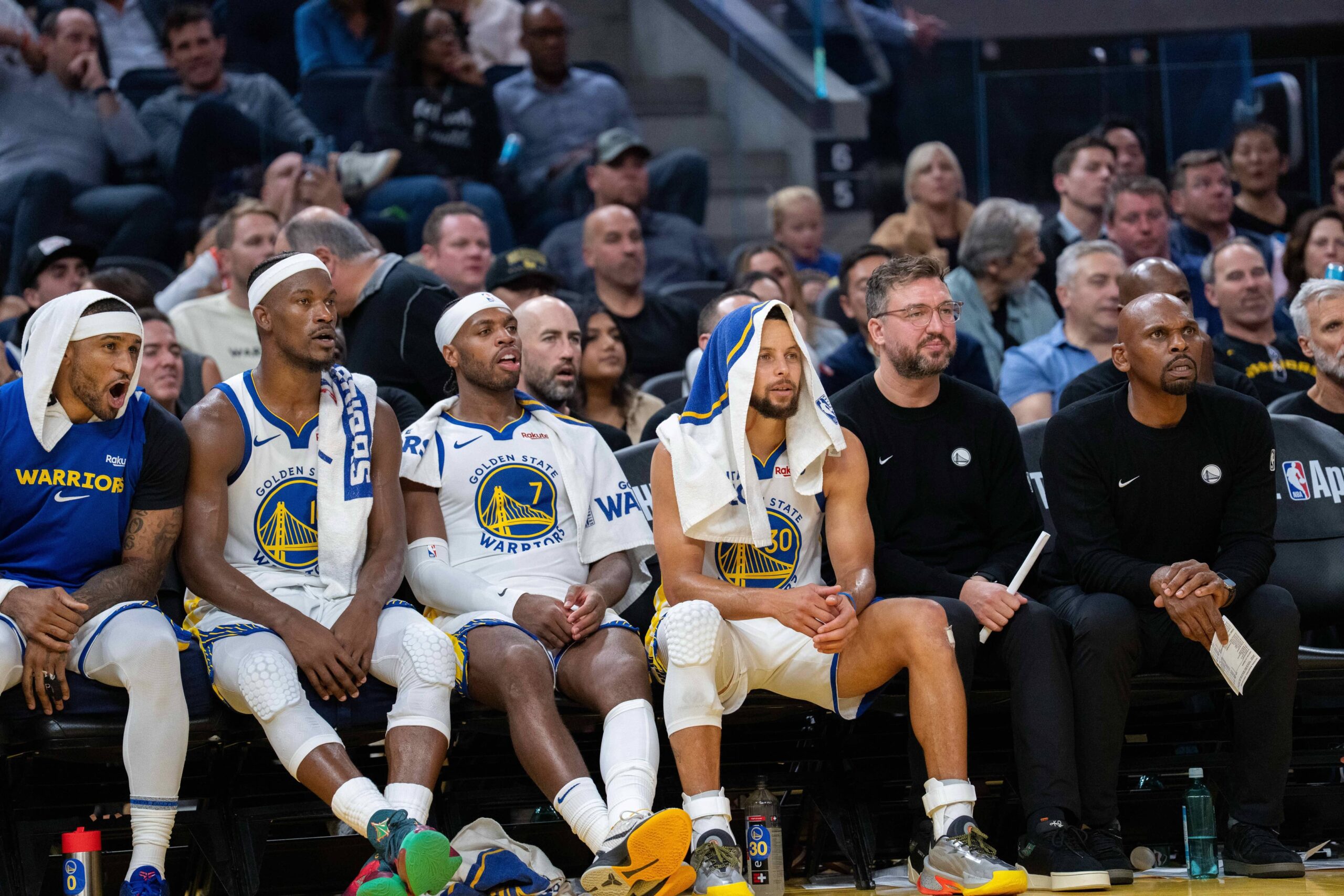 San Francisco, California, USA; Golden State Warriors guard Stephen Curry (30) on the bench with forward Jimmy Butler III (10) and guard Buddy Hield (7) and guard Gary Payton II (0) during the game against the LA Clippers during the fourth quarter at Chase Center. Mandatory Credit: Neville E. Guard-Imagn Images