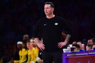 Los Angeles, California, USA; Los Angeles Lakers head coach JJ Redick watches game action against the Golden State Warriors during the first half at Crypto.com Arena. Mandatory Credit: Gary A. Vasquez-Imagn Images