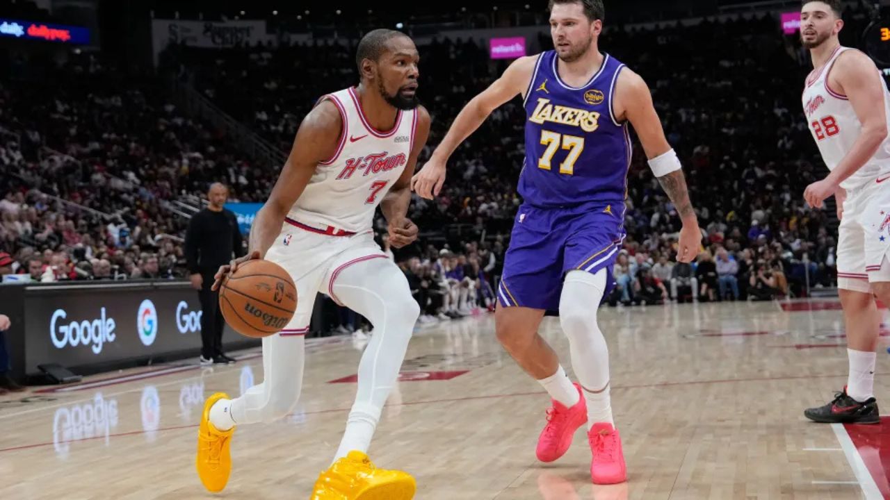 Houston Rockets’ Kevin Durant (7) drives toward the basket as Los Angeles Lakers’ Luka Doncic (77) defends during the first half of an NBA basketball game Wednesday, March 18, 2026, in Houston. (AP Photo/David J. Phillip)
