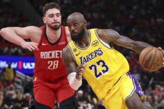 Apr 24, 2026; Houston, Texas, USA; Los Angeles Lakers forward LeBron James (23) drives with the ball as Houston Rockets center Alperen Sengun (28) defends during the fourth quarter during game three of the first round of the 2026 NBA Playoffs at Toyota Center. Mandatory Credit: Troy Taormina-Imagn Images