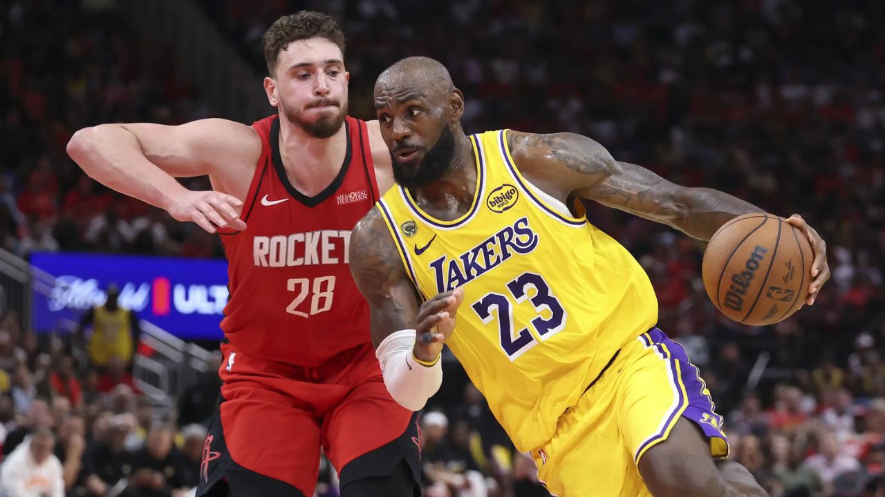 Apr 24, 2026; Houston, Texas, USA; Los Angeles Lakers forward LeBron James (23) drives with the ball as Houston Rockets center Alperen Sengun (28) defends during the fourth quarter during game three of the first round of the 2026 NBA Playoffs at Toyota Center. Mandatory Credit: Troy Taormina-Imagn Images