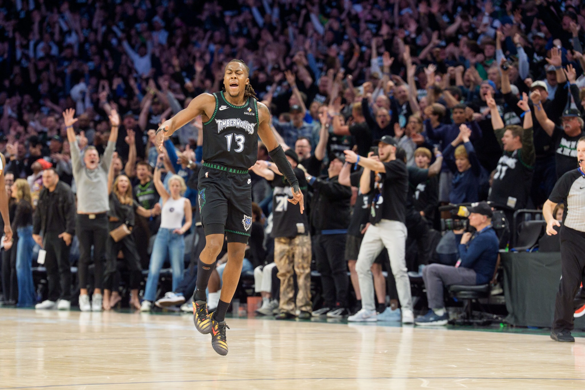 Apr 25, 2026; Minneapolis, Minnesota, USA; Minnesota Timberwolves guard Ayo Dosunmu (13) celebrates with fans after making a three-point shot against the Denver Nuggets in the fourth quarter at Target Center. Mandatory Credit: Matt Blewett-Imagn Images