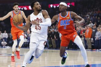 Nov 8, 2023; Oklahoma City, Oklahoma, USA; Cleveland Cavaliers guard Donovan Mitchell (45) drives to the basket against Oklahoma City Thunder guard Shai Gilgeous-Alexander (2) during the first quarter at Paycom Center. Mandatory Credit: Alonzo Adams-Imagn Images