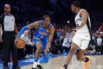 Jan 13, 2026; Oklahoma City, Oklahoma, USA; Oklahoma City Thunder guard/forward Jalen Williams (8) drives down the court beside San Antonio Spurs guard De'aaron Fox (4) during the second half at Paycom Center. Mandatory Credit: Alonzo Adams-Imagn Images