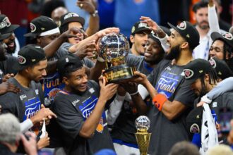 Cleveland, Ohio, USA; New York Knicks lift the 2026 Eastern Conference trophy after defeating the Cleveland Cavaliers in game four of the eastern conference finals for the 2026 NBA playoffs at Rocket Arena. Mandatory Credit: David Richard-Imagn Images