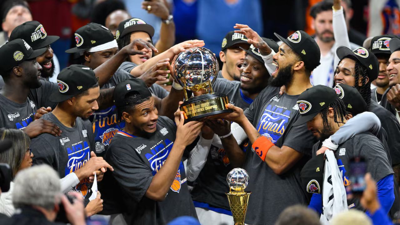 Cleveland, Ohio, USA; New York Knicks lift the 2026 Eastern Conference trophy after defeating the Cleveland Cavaliers in game four of the eastern conference finals for the 2026 NBA playoffs at Rocket Arena. Mandatory Credit: David Richard-Imagn Images