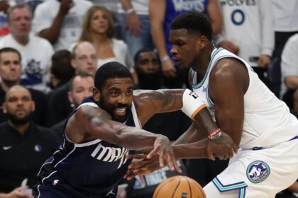 May 22, 2024; Minneapolis, Minnesota, USA; Dallas Mavericks guard Kyrie Irving (11) controls the ball against Minnesota Timberwolves guard Anthony Edwards (5) i the first quarter during game one of the western conference finals for the 2024 NBA playoffs at Target Center. Mandatory Credit: Jesse Johnson-USA TODAY Sports