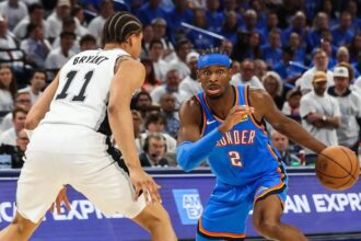Oklahoma City, Oklahoma, USA; Oklahoma City Thunder guard Shai Gilgeous-Alexander (2) looks to pass as San Antonio Spurs forward Carter Bryant (11) defends during the third quarter during game two of the western conference finals for the 2026 NBA playoffs at Paycom Center. Mandatory Credit: Brett Rojo-Imagn Images