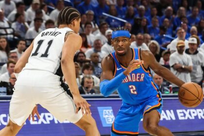 Oklahoma City, Oklahoma, USA; Oklahoma City Thunder guard Shai Gilgeous-Alexander (2) looks to pass as San Antonio Spurs forward Carter Bryant (11) defends during the third quarter during game two of the western conference finals for the 2026 NBA playoffs at Paycom Center. Mandatory Credit: Brett Rojo-Imagn Images