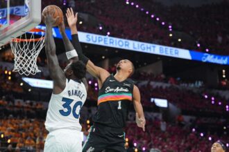 May 4, 2026; San Antonio, Texas, USA; Minnesota Timberwolves forward Julius Randle (30) shoots against San Antonio Spurs forward Victor Wembanyama (1) in the first half during game one of the second round of the 2026 NBA Playoffs at Frost Bank Center. Mandatory Credit: Daniel Dunn-Imagn Images