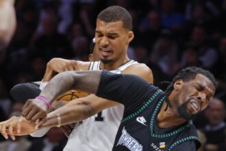 May 10, 2026; Minneapolis, Minnesota, USA; San Antonio Spurs center Victor Wembanyama (1) commits a level two flagrant foul against Minnesota Timberwolves center Naz Reid (11) in the second quarter of game four of the second round of the 2026 NBA Playoffs at Target Center. Wembanyama had to leave the game. Mandatory Credit: Bruce Kluckhohn-Imagn Imagesv