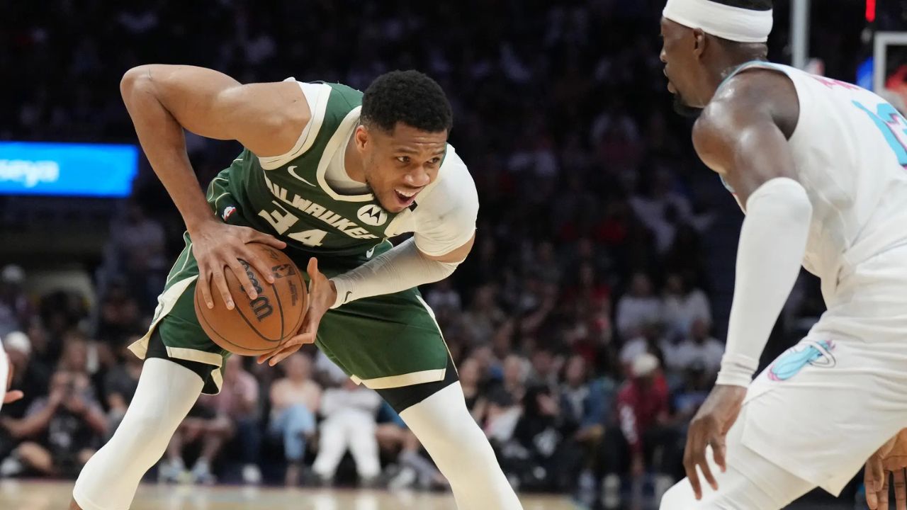 Apr 5, 2025; Miami, Florida, USA; Milwaukee Bucks forward Giannis Antetokounmpo (34) looks to pass the ball as Miami Heat center Bam Adebayo (13) defends during the second half at Kaseya Center. Mandatory Credit: Jim Rassol-Imagn Images