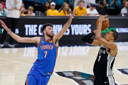 SAN ANTONIO, TX - MAY 22: Victor Wembanyama #1 of the San Antonio Spurs shoots over Chet Holmgren #7 of the Oklahoma City Thunder in the fourth quarter of Game Three of the Western Conference Finals NBA Playoffs at Frost Bank Center on May 22, 2026 in San Antonio, Texas. (Photo by Ronald Cortes/Getty Images)