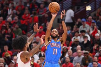 Isaiah Joe #11 of the Oklahoma City Thunder shoots over Coby White #0 of the Chicago Bulls during the first half at the United Center on October 25, 2023 in Chicago, Illinois.