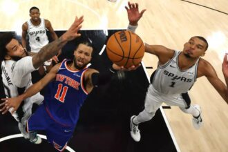 New York’s Jalen Brunson shoots between San Antonio’s Julian Champagnie, left, and Victor Wembanyama during the fourth quarter of the Knicks’ 105-104 win in Game 2 of the NBA Finals on Friday night. (Gregory Shamus / Getty Images)