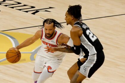 Jun 3, 2026; San Antonio, Texas, USA; New York Knicks guard Jalen Brunson (11) dribbles the ball against San Antonio Spurs guard Devin Vassell (24) in the first half during game one of the 2026 NBA Finals at Frost Bank Center. Mandatory Credit: Geoff Burke-Imagn Images