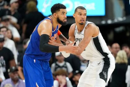 Jun 5, 2026; San Antonio, Texas, USA; New York Knicks center Karl-Anthony Towns (32) and San Antonio Spurs forward Victor Wembanyama (1) look for the ball in the second half during game two of the 2026 NBA Finals at Frost Bank Center. Mandatory Credit: Scott Wachter-Imagn Images