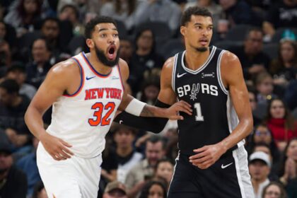 San Antonio Spurs center Victor Wembanyama (1) guards New York Knicks center Karl-Anthony Towns during the second half of an NBA basketball game, Wednesday, Dec. 31, 2025, in San Antonio. (AP Photo/Darren Abate)